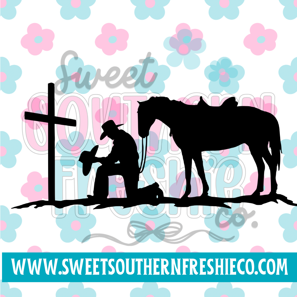 Cowboy kneeling at cross