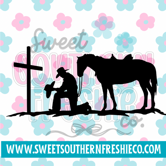 Cowboy kneeling at cross