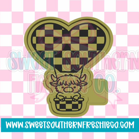 Highland cow in Checkered air balloon